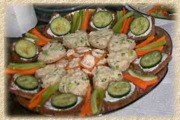 A tray of tea sandwiches with cucumber, carrots and celery